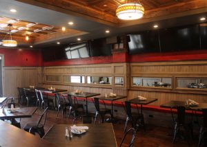 Back Dining Room with Tables & Flat Screen TVs.