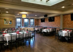 Private Catering Room showing tables set, buffet station and flat screen tvs on the walls.