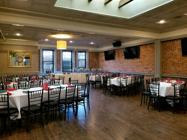 Private Catering Room showing tables set, buffet station and flat screen tvs on the walls.
