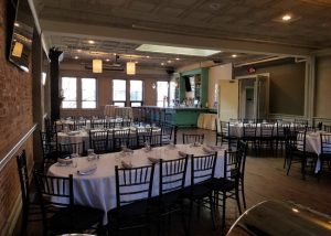 Upstairs Private Party Room photo showing large banquet tables.